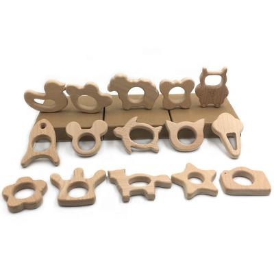 China Europe Professional Unfinished Natural Wood Carved Animals Shapes Baby Wooden Teether Toy for sale