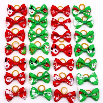 China Viable Mix Styles Dog Bows Christmas Santa Deer Snowman Small Dog Cat Hair Bows With Rubber Band Pet Grooming Accessories for sale