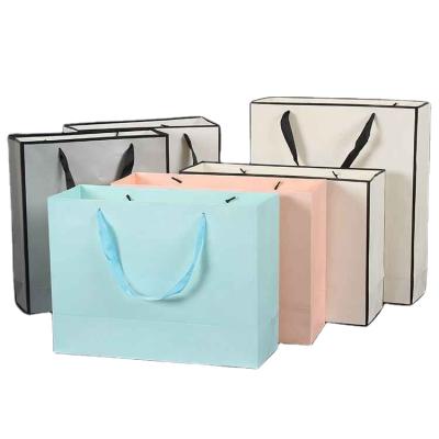 China Custom Recyclable Wholesale Advertising Paper Clothing Tote Bag Shopping Gift Tote Bag Custom Logo for sale