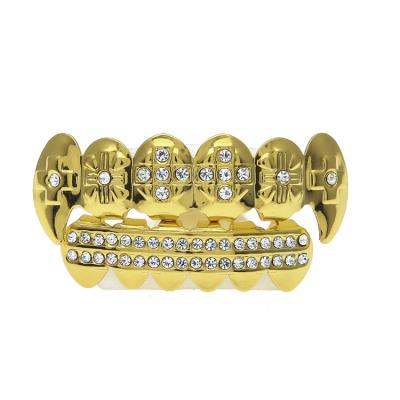 China Custom Hip Hop Gold Color Iced Out Rhinestones Teeth Grillz Top&Bottom Vampire Tooth Caps Hip Hop Blingbling Copper Body Jewelry for sale