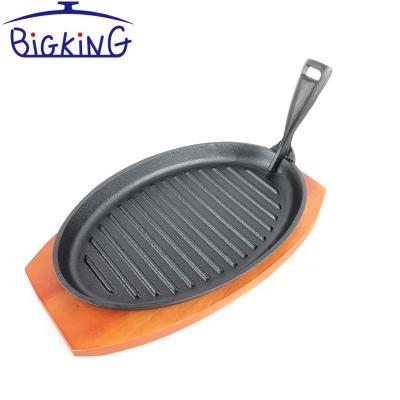 China Height Adjustable Oval Shape Serving Plate Cast Iron Steak Dish With Wooden Base for sale