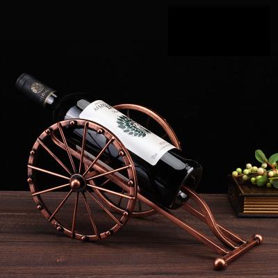 China Viable Wholesale Creative Wine Decor Rack Holder Ornament Cannon Form Simple Stainless Steel Wine Glass Rack for sale