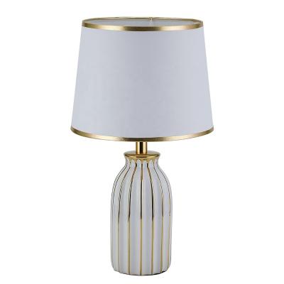 China Modern hot sale luxury line gold ceramic table lamp for hotel living room decoration for sale