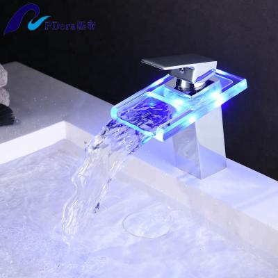 China Metered Faucets Deck Mounted Glass Bathroom Sink Waterfall Faucet With Led Lights for sale