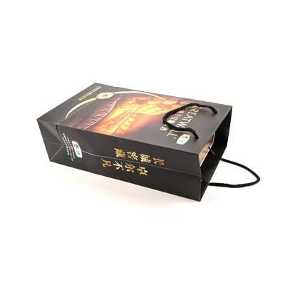 China Recyclable Custom High Quality Black Logo Gold Foil Stamping Matt Paper Bag With Ribbon Handle Bag Paper for sale