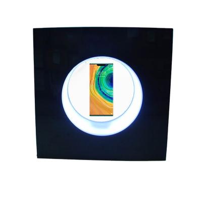 China Eco-friendly Smart Phone Levitating Show Innovative Mobile Phone Acrylics Show Automatic Rotation Led Lighting Display for sale