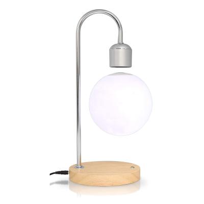 China 2022 Unique Modern Suspended Moon Table Lamps Factory Best Sellers Magnetic Wood Base Light Bulb Suspension LED Table Lamps for sale