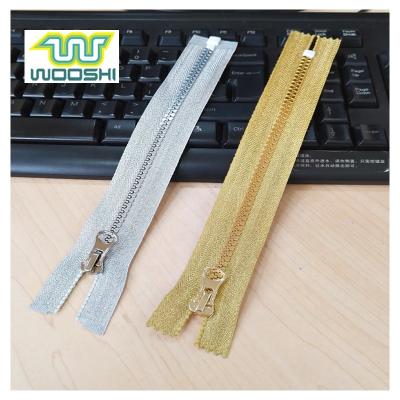 China Sustainable Fashion Spun Gold Strip Plastic Zipper Spun Plastic Silver Strip Zipper For Fashionable Garment for sale