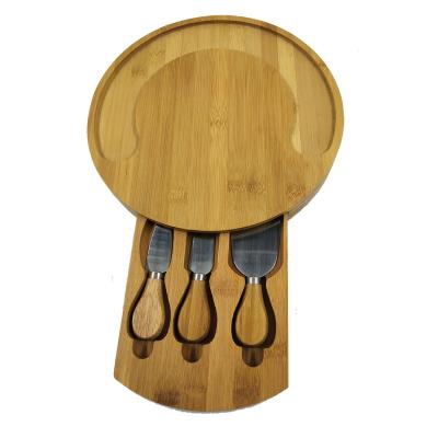 China 2022 New Sustainable Round Large Bamboo Panel Cheese Board Set Cutting Dishes And Knife Set With Hidden Wooden Slide Drawers Charcuterie Tray B for sale