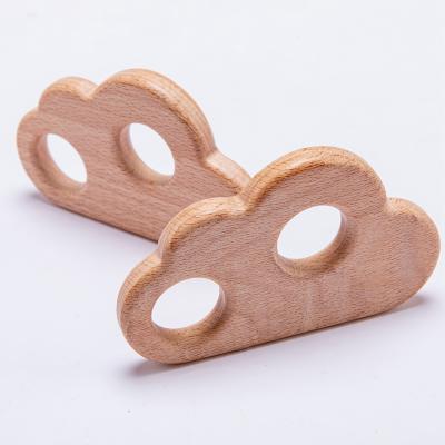 China Natural Eco-friendly Baby Teether Food Grade Beech Wooden Teether Toy Cloud Double Hole Teeth for sale