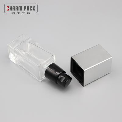 China Wholesale Cosmetic Packaging 30ml Square Base Glass Cosmetic Bottle With 18/410 Pump for sale