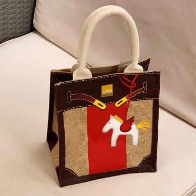 China Easy To Carry Material Cartoon Pattern Horse Jute Red Yellow Quilted Striped Bag for sale