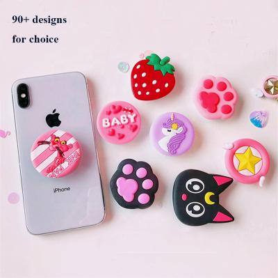 China Custom 3D Cartoon PVC+ABS Style Universal Cell Phone Bracket Soft Rubber Phone Socket Holder for sale