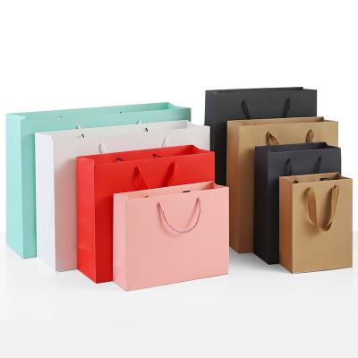 China Custom Reusable Handmade Paper Clothing Eco Friendly Personalized Gift Shopping Bags With Your Own Logo for sale