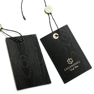 China Black Embossed Paper Luxury Hang Tag With String Printed Logo Clear Pvc Tag Garment Clothing Custom Hang Tags for sale