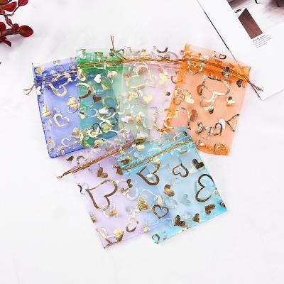 China Disposable gold heart printed cheap price 7*9 cm organza cord gift bags jewelry pouch for sale