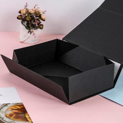 China Materials Recycled In Stock Black And White Cardboard Magnet Closure Foldable Packaging Paper Gift Box For Wigs for sale