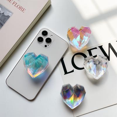 China Adjustable Korea ins Transparent Laser Heart Shape Finger Ring Socket Talk Holder Foldable Elastic Phone Holder for iPhone Samsung Xiaomi for sale