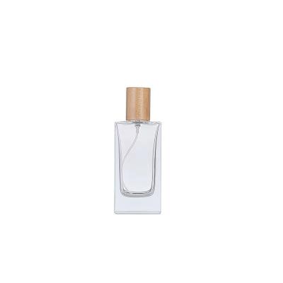 China Wholesale Cosmetic Transparent Empty Glass Spray Bottles Perfume Bottle With Wooden Lid for sale