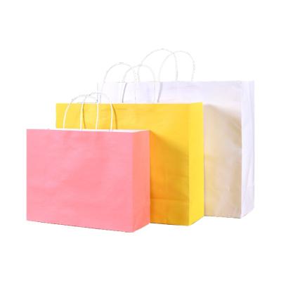 China Biodegradable Yellow Reliable Paper Bag Logo Printing Gift Bag Hot Sale Clothing Package Bag for sale