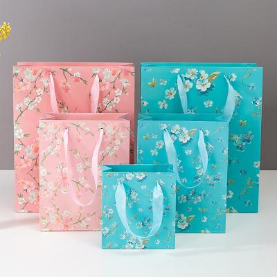 China Custom Luxury Recycled Materials Clothes Store Retail Packaging Gift Carry Bags Boutique Shopping Paper Bags With Your Own Logo for sale