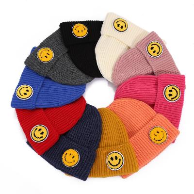 China COMMON Fashion Cute Comfortable Custom Embroidery Acrylic Knitted Hat Smile Face Winter Beanie Hat for sale