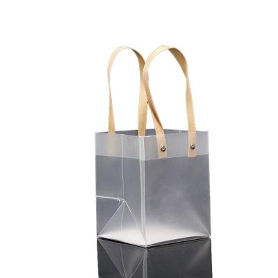 China Gift Bag Moisture Proof Bag Semi-transparent Plastic T-shirt Frosted Transparent PP Bags With Paper Handle for sale