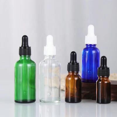 China Cosmetic DVI Amber Glass Dropper Bottle Cheap Round Shape Plastic Cap Color Coated Essential Oil Bottles For Perfumes And More Oils for sale