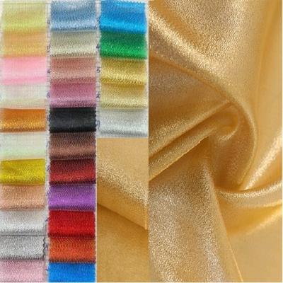 China Anti-static fashionable glitter silver silk dress fabric decorates toy gold silk fabrics for sale