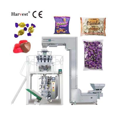 China High Speed ​​Vertical Food Packing Machine Gummy Candy, Lollipop, Nuts, French Fries Snacks Small Weighing And Packaging Machine for sale