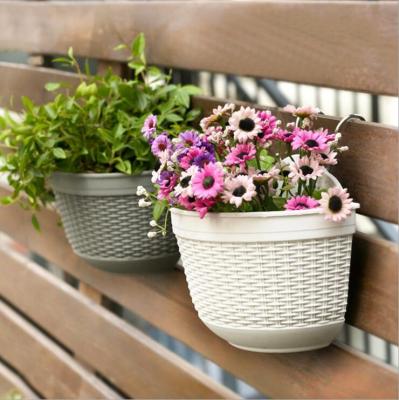 China Flower pot like a modern plastic wall hanging flower pot hanging resin semicircular creative rattan for sale