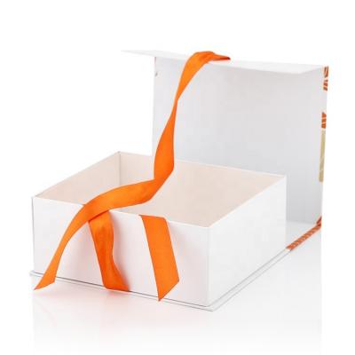 China Biodegradable Custom Luxury White Foldable Magnet Closure Clothing Paper Box Magnet Flap Gift Boxes With Black Ribbon for sale