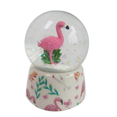 China Europe Valentine's Day Gift Snow Globe Water Globe Resin Flamingo Snow Globe Glass for sale