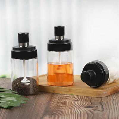 China Stocked Household Kitchen Sealed Oil Brush Honey Seasoning Bottle With Spoon Seasoning Cover for sale