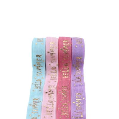 China Holiday Decoration Fancy Logo ENEMY Ribbon Custom Elastic Gold Foil Printed Ribbon For Holiday Decoration for sale