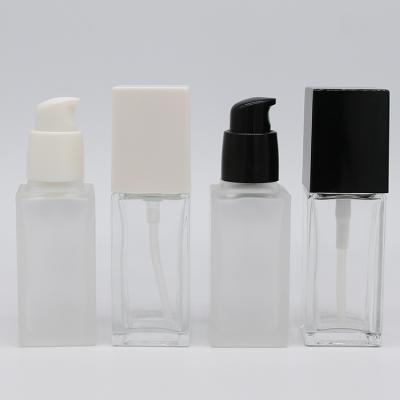 China 30ml Luxury Liquid Square Cosmetic Pump Packaging Glass Bottle Personal Care Base Pump Clear Frosted Glass Bottle With Matte White Pump for sale