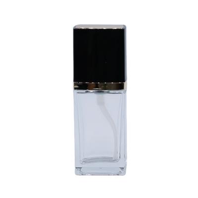 China Luxury Cosmetic Square Glass Essence Bottle Powdery Bottom Packaging 30ml 1oz Liquid Bottle With Pump Cap for sale