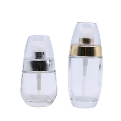 China Luxury Wholesale Empty Cosmetic Packaging 30ml 50ml Oval Powdery Bottom Bottle Lotion Glass Liquid Bottles With Pump for sale