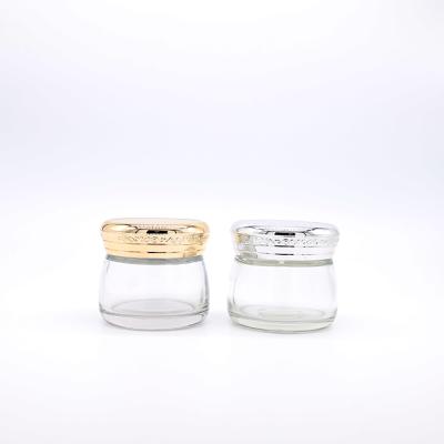 China Luxury Clear Round 100g Tall Glass Jars Cosmetic Face Cream Jar With Gold Silver Screw Cap for sale