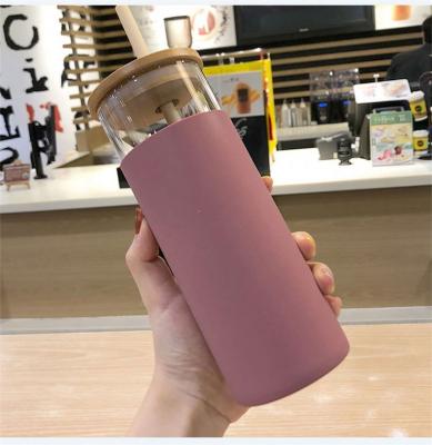 China Sustainable Factory Customized Fashion Sports Glass Water Bottle With Silicone Sleeve And Wooden Straw for sale