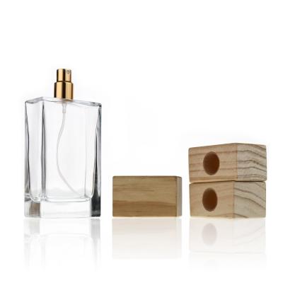 China Largest Capacity Dubai Style100ml Cosmetic Empty Square Perfume Glass Bottles With Wooden Cap For Perfume for sale