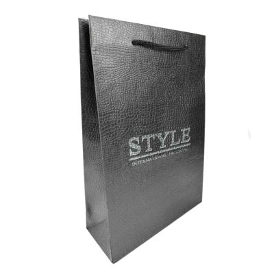 China Recycled materials wholesale high quality customized crocodile texture special paper bag with string handle logo black embossed paper bag for sale