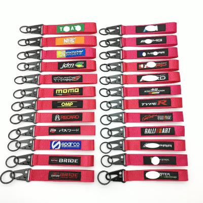 China Custom Wholesale Nylon Woven Car Accessories Logo Keyring Buckle Decoration Gift Refitting Nylon Red Key Chain Label Emblem for sale