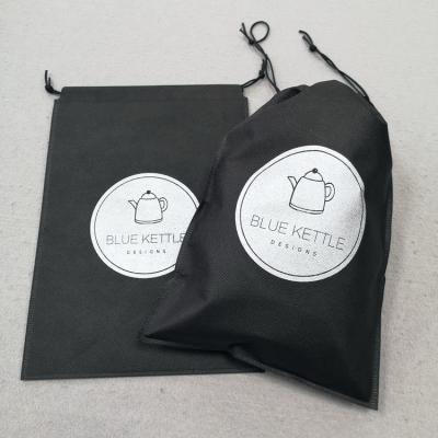 China Black Nonwoven Clothing Packaging Bag With Logo Custom Non Plastic Drawstring Carry Bag For Apparel for sale