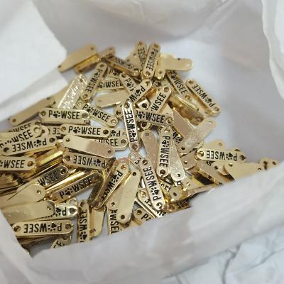 China Washable Custom Clothing Logo Label With Engraved Clothing Label Tag Handbag Accessories Gold Triangle Logo for sale