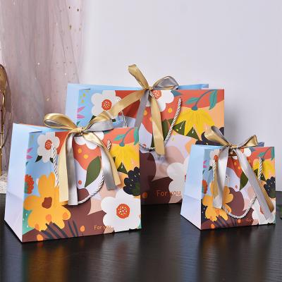 China Wholesale Custom Recyclable Packaging Gift Bags Beautiful Recyclable Flower Bird Colored Gift Fancy Paper Bag With Ribbon Bow Tie Ribbon Handle for sale