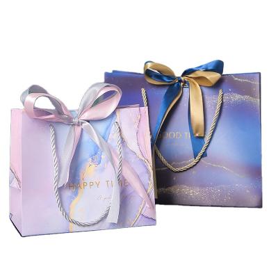 China Wholesale Custom Logo Beautiful Recyclable Custom Logo Jewelry Gift Bags Packaging Apparel Birthday Gift Paper Bags With Bow Tie Ribbon Handle for sale