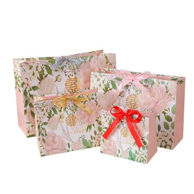 China Luxury Recyclable Wholesale JuYi Ins Style Flower Pattern Birthday Wedding Jewelry Gift Wrapping Paper Bag With Bow Tie Ribbon for sale