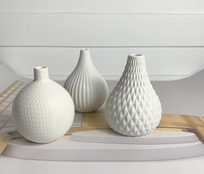 China Modern Patterns Allow It To Mix With Any Room Dropshipping Matte White Ceramic Vases Nordic Geometric Design Around Reed Diffuser Bud Vases Perfume Bottle For Office Home Decor for sale