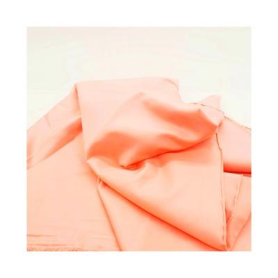 China Shrink-Resistant Imitation Silk Elastic Fabric Smooth Dyed Orange Imitated Silk Fabric For Women/Men for sale